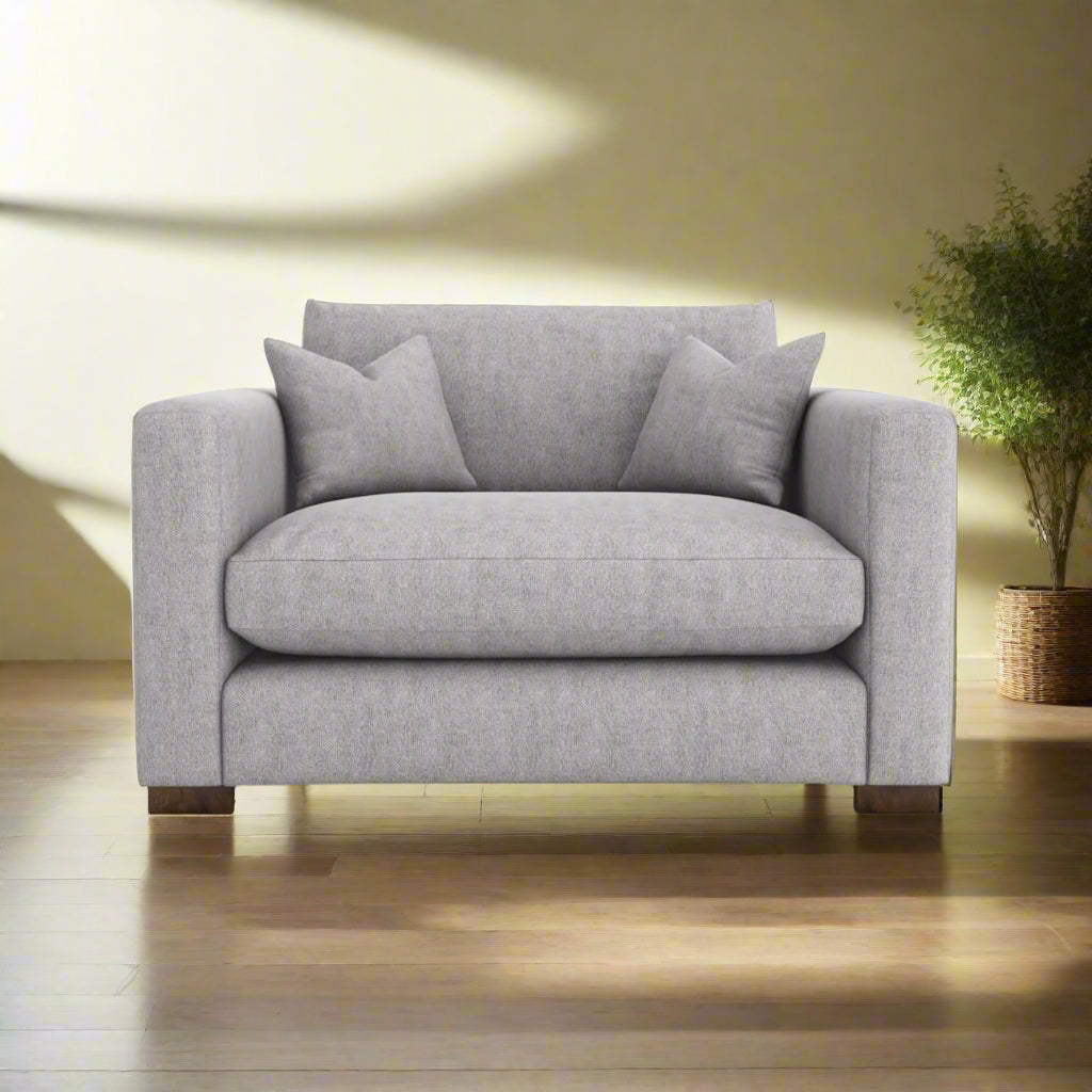 Gray sofa with cushions on a white background